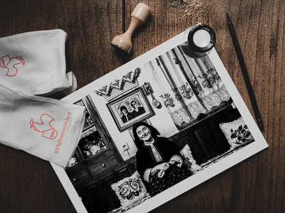 Black and White Photography Wall Art Greece | Woman in a traditional house Olympos Karpathos Dodecanese by George Tatakis - photo print on table
