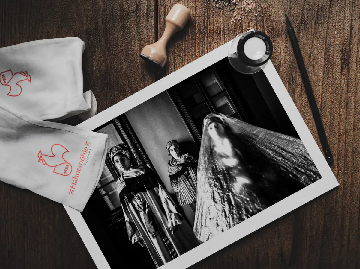 Black and White Photography Wall Art Greece | Three ladies in the traditional costumes of Symi island inside a room Dodecanese Greece by George Tatakis - photo print on table