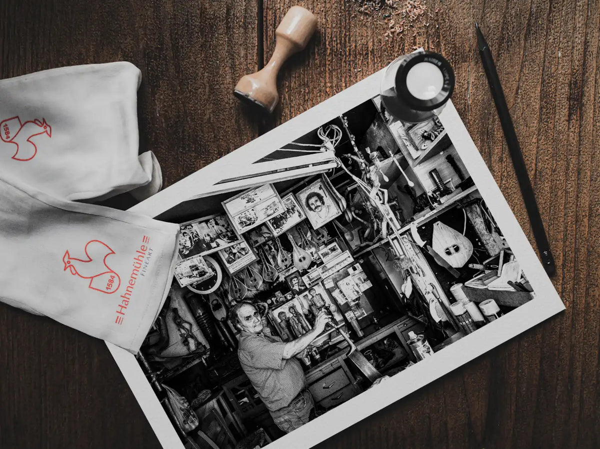 Black and White Photography Wall Art Greece | Man in his music instrument workshop Anogia Crete by George Tatakis - photo print on table