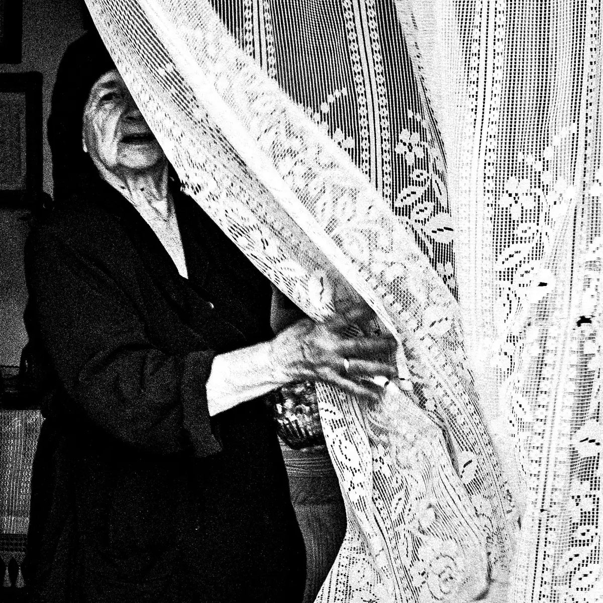 Black and White Photography Wall Art Greece | Lady in Anogia behind a curtain Crete by George Tatakis - detailed view