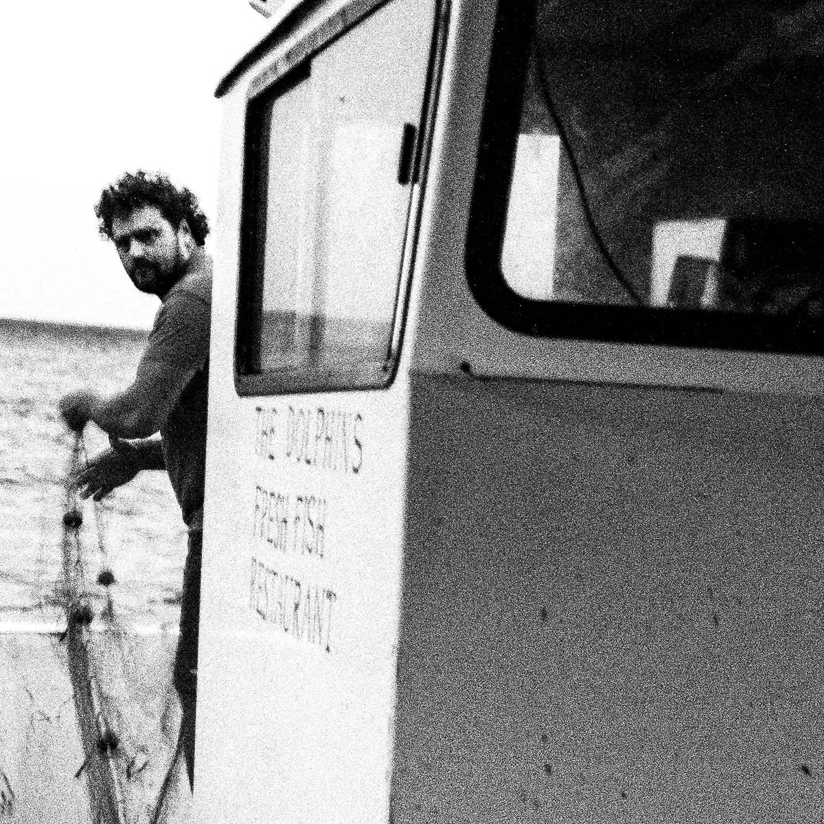 Black and White Photography Wall Art Greece | Fisherman with nets on his boat in Diafani Olympos Karpathos Dodecanese by George Tatakis - detailed view