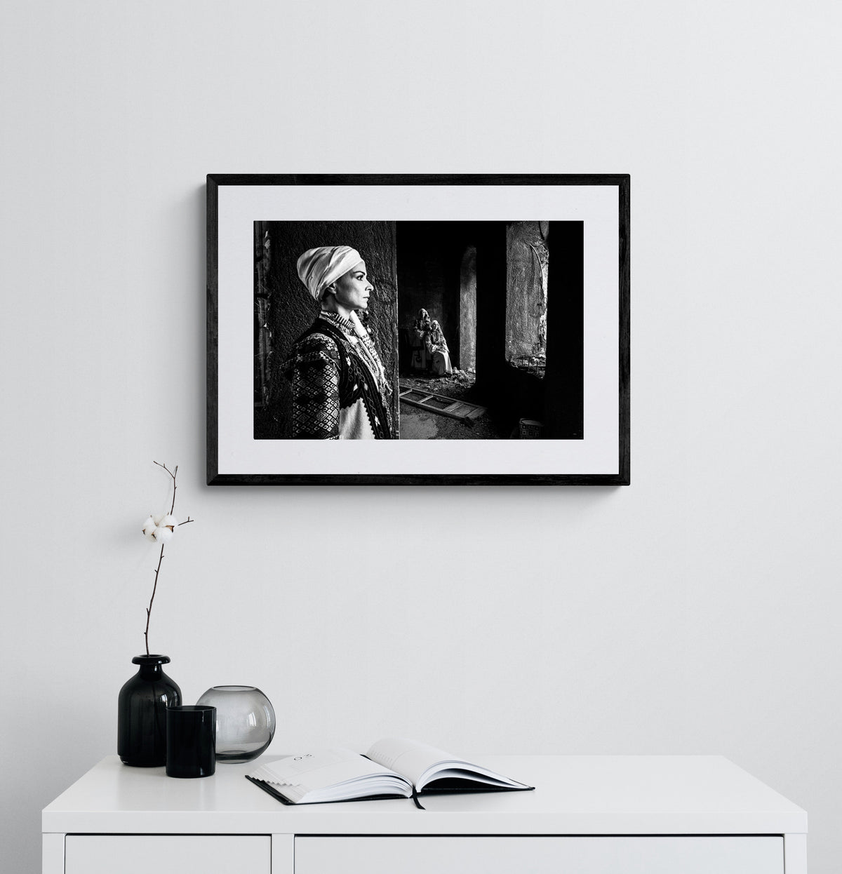 Woman in profile and two supporting figures in Kyparissia costumes, Peloponnese, Greece. Black and white photography framed on a wall by George Tatakis.