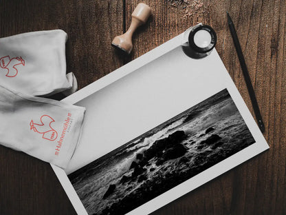Santorini, Waves crushing on a boulder | Chorōs | Black-and-white wall art photography from Greece - photo print on table