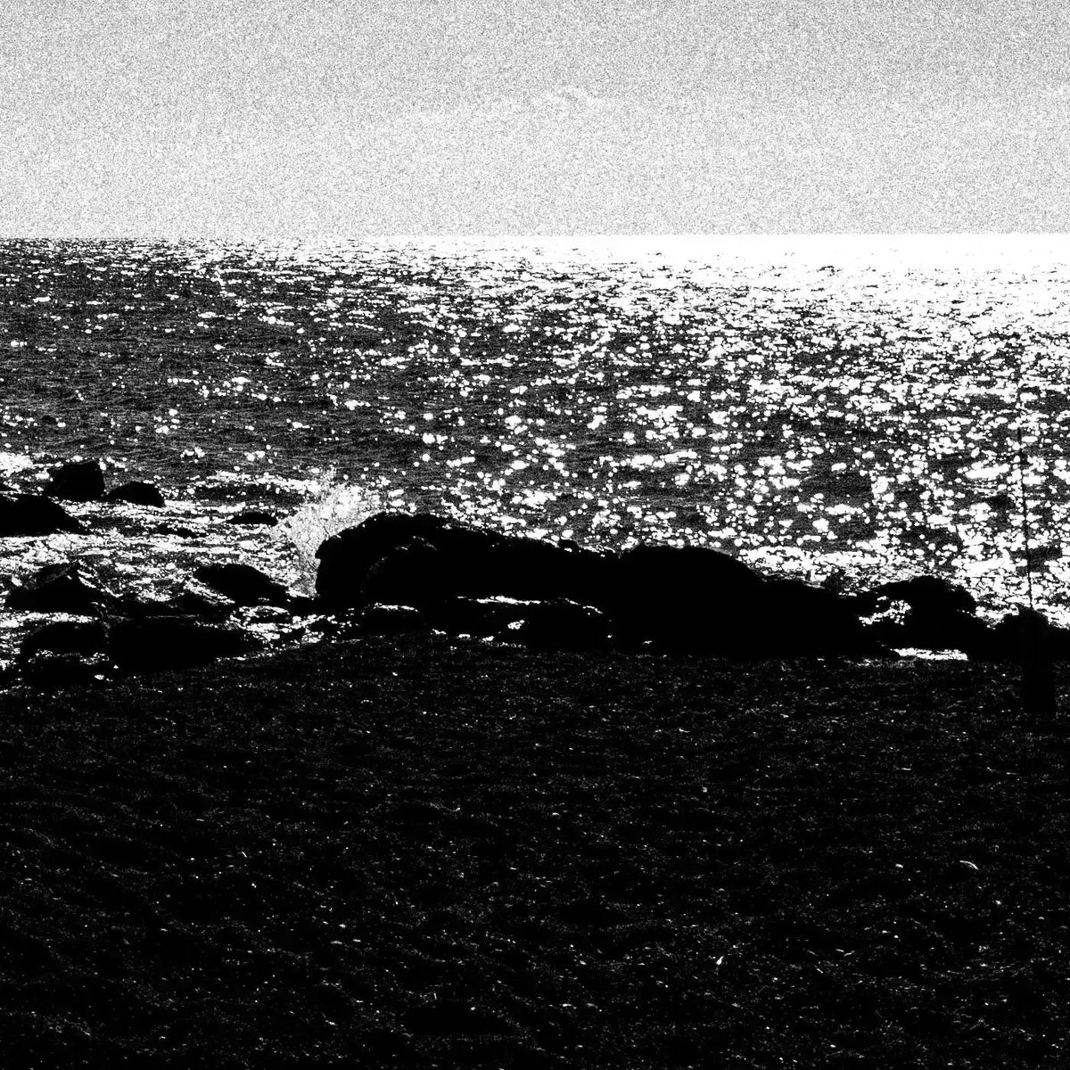 Calm Sunlit Sea | Santorini | Chorōs | Black-and-white wall art photography from Greece - detailed view