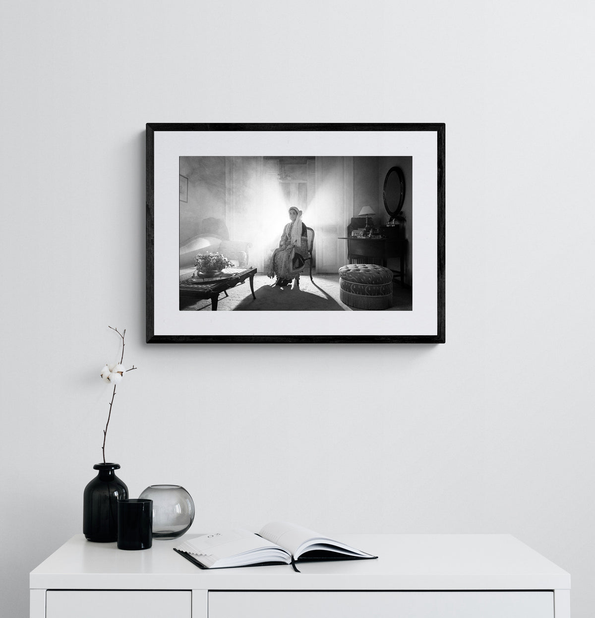 Sitting portrait of a woman in the urban costume of Kalamata, shot at the Lyceum Club of Greek Women. Peloponnese, Greece. Black and white photography framed on a wall by George Tatakis.