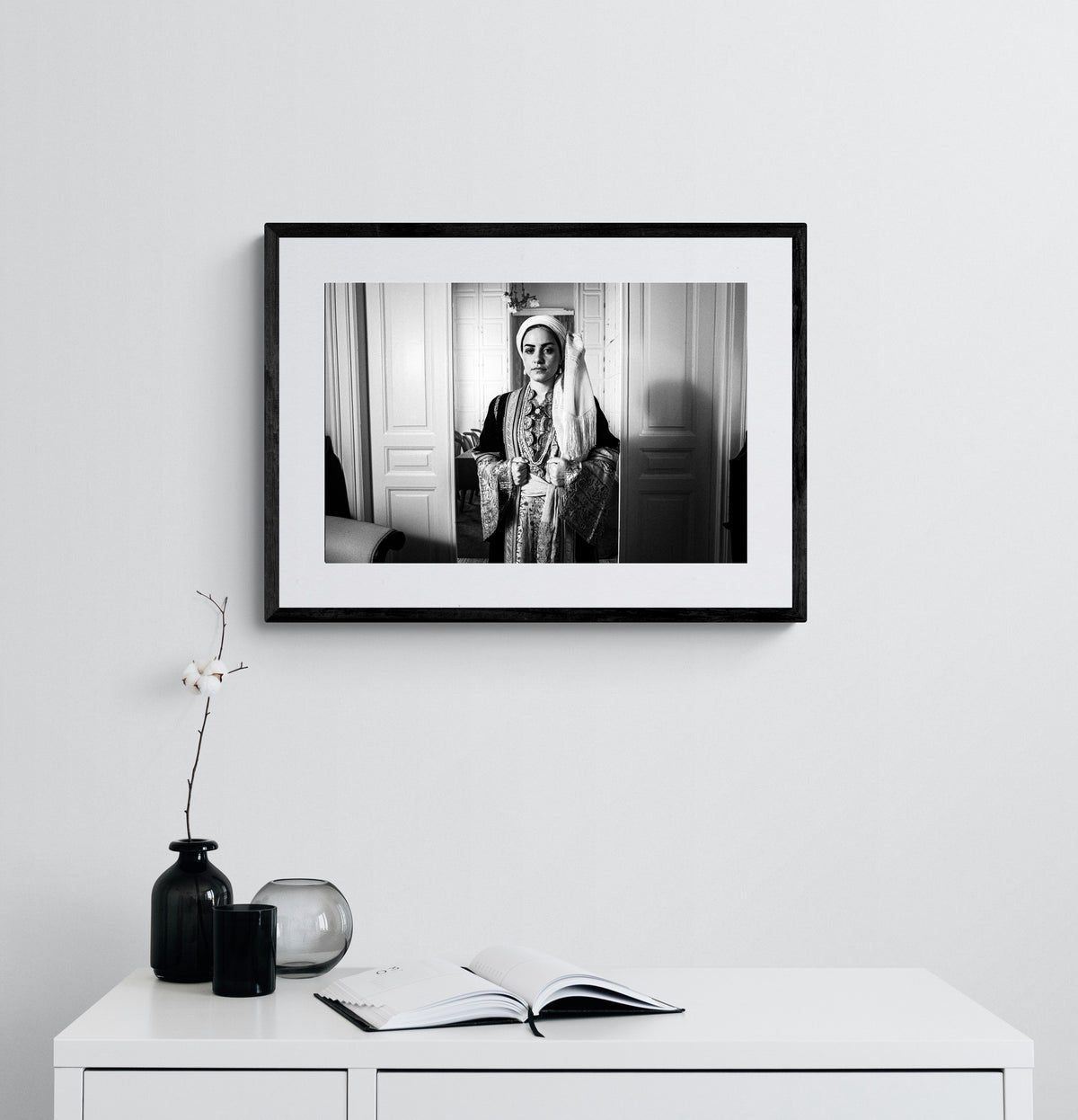 Portrait of a woman in the urban dress of Kalamata at the Lyceum Club of Greek Women. Peloponnese, Greece. Black and white photography framed on a wall by George Tatakis.