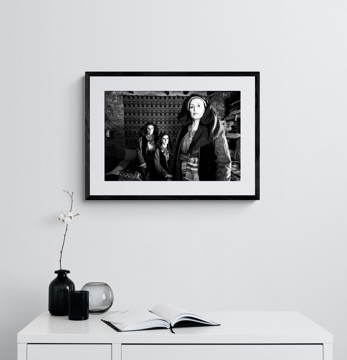 Three women in Alagonia local costumes. Nedoussa, Peloponnese, Greece. Black and white photography framed on a wall by George Tatakis.